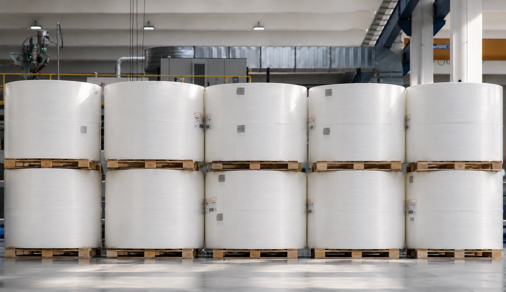 Large rolls of material on wooden pallets.